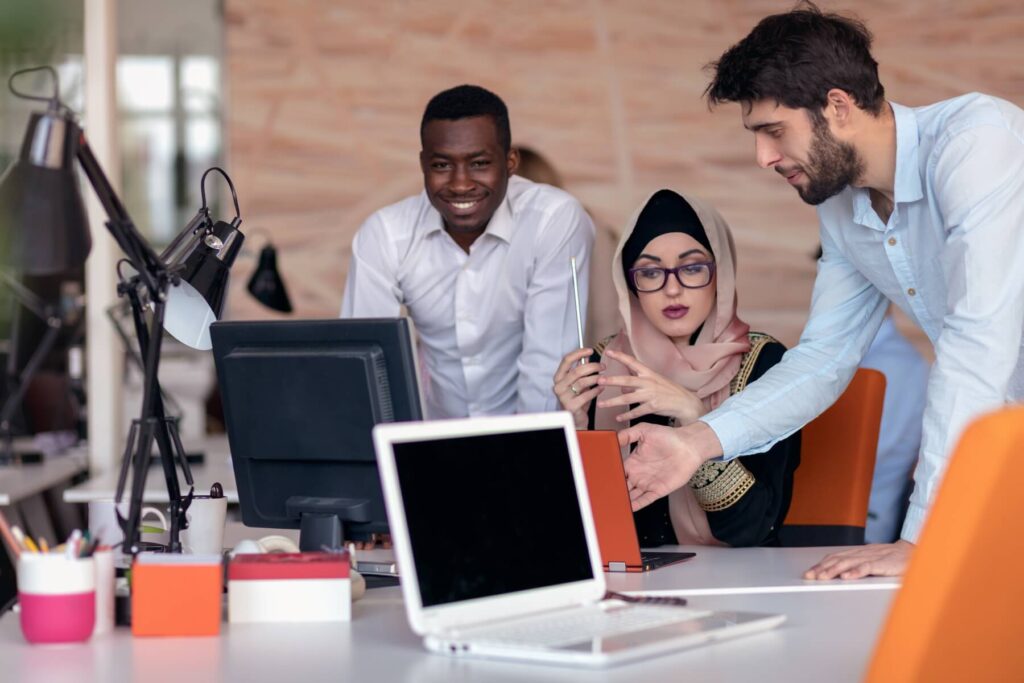 A group of colleagues discuss around a conference table