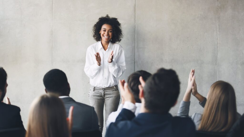 A speaker addresses a group of businesspeople