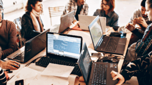 People working on computers around a table